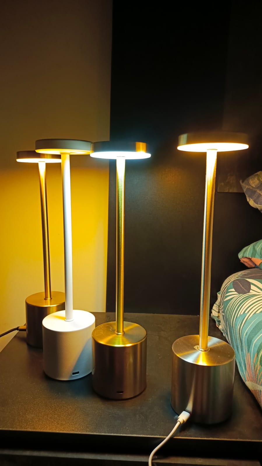 Set of LED table lamps on a dark surface with a blurred background