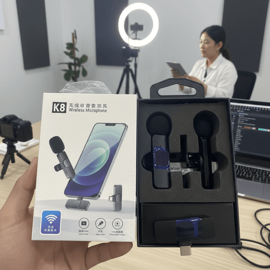 K8 wireless microphone set with packaging held by a hand, in an office setting. mypickmart