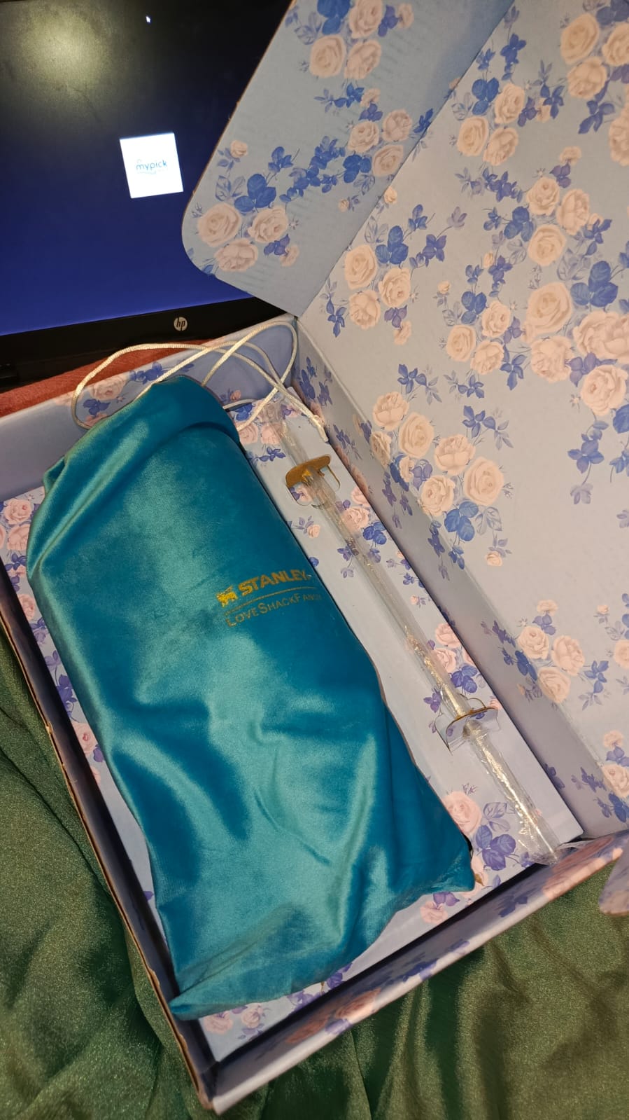 Tumbler stanley  with case and cloth on a floral-patterned surface , mypickmart