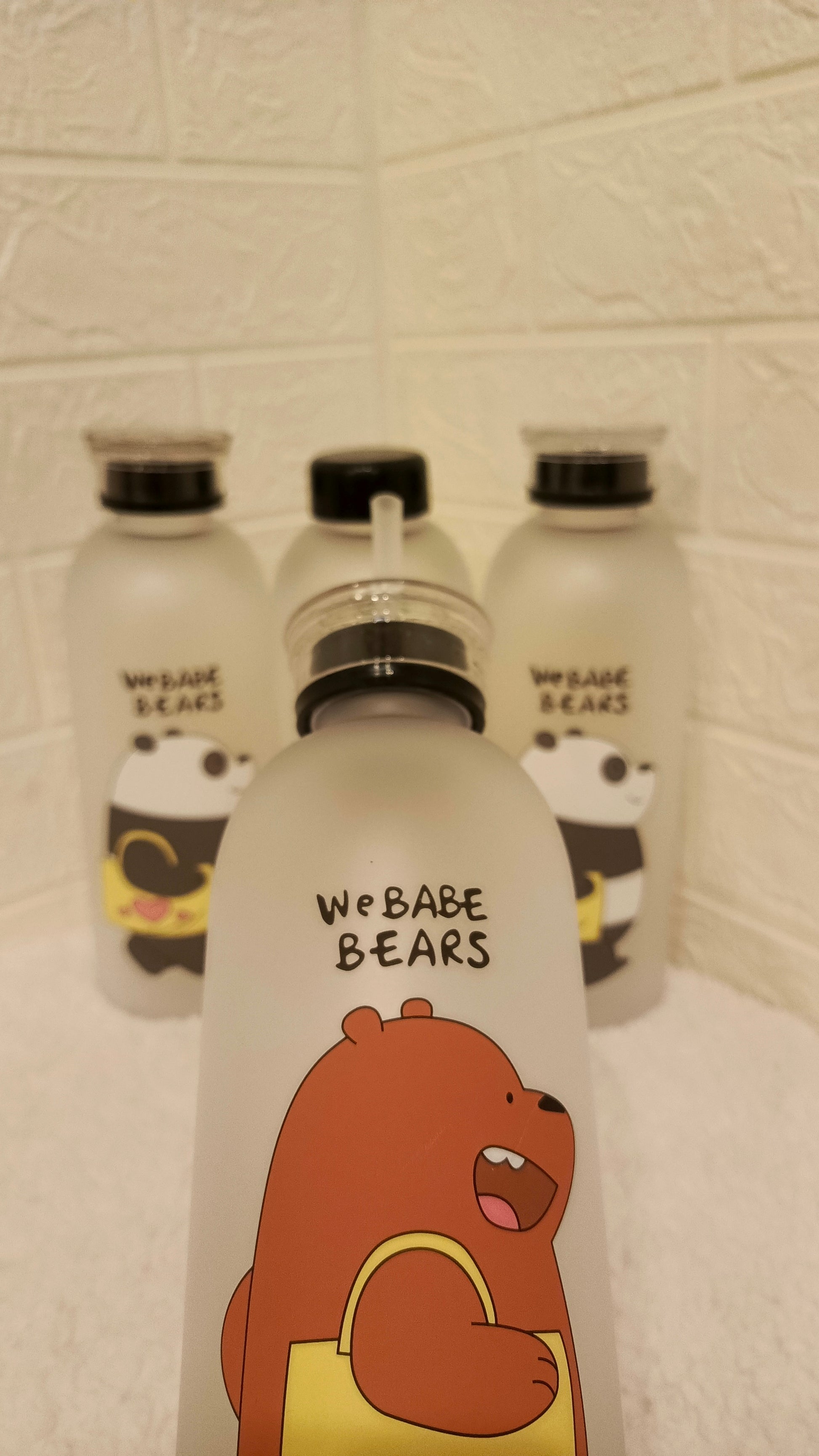 Set of bear-themed water bottles with cartoon characters on a textured  We BABE BEARS Froasted Plastic Bottles surface.