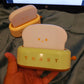 Small toaster toy held in a hand with a screen displaying 'mypick mart' in the background.