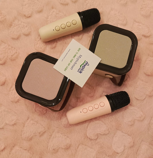 Two beige microphones with black foam covers on a textured pink surface, featuring the 'Nipper' brand.